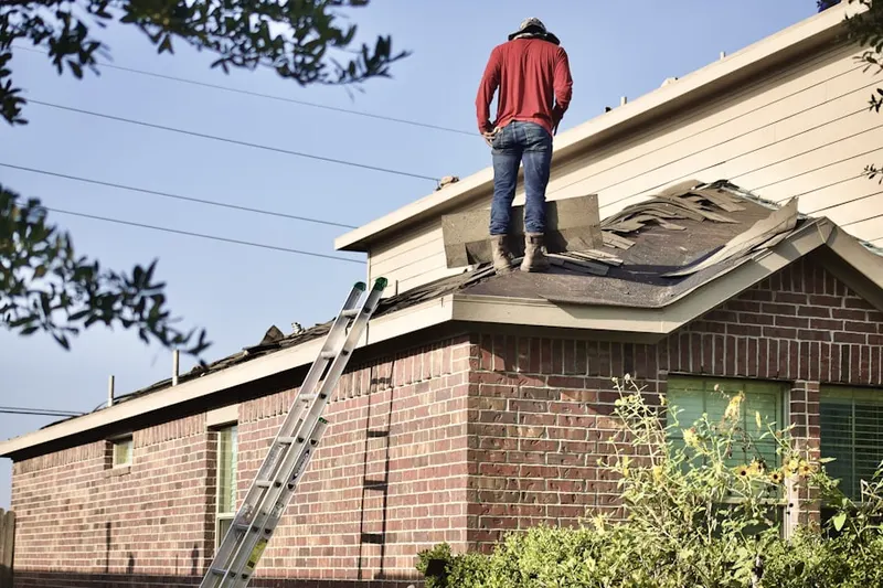 Professional roofer working on a residential roof in Fairmont